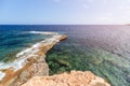 Widescreen shot: narrow strip of rocky coast goes deep into sea forming small bay with clear transparent water,ÃÂ Ibiza